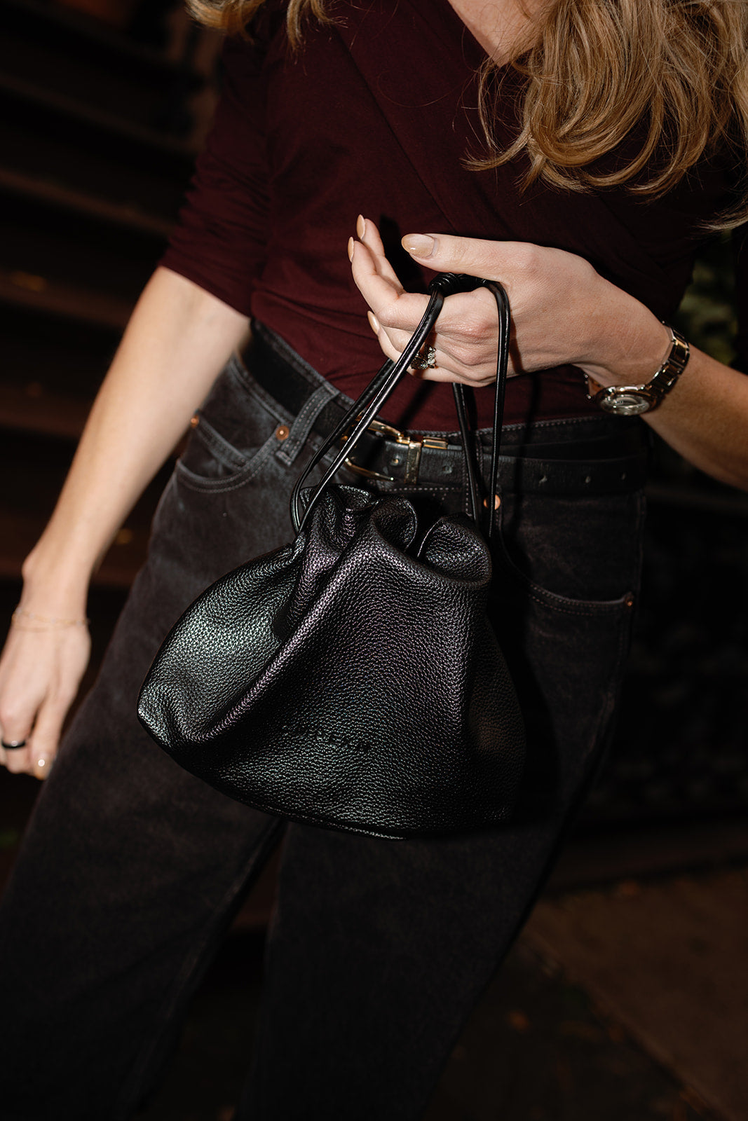 CMPLXN black drawstring bag carried